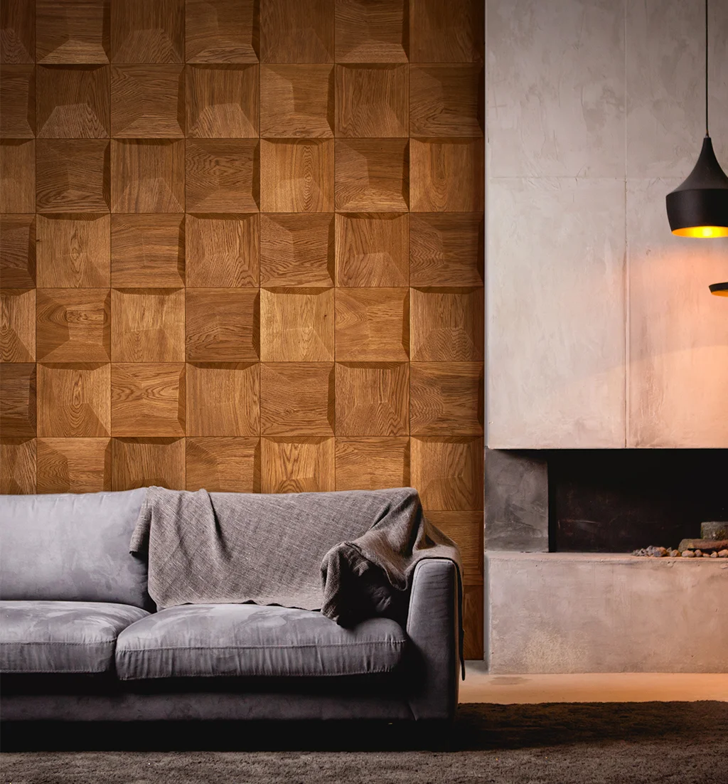 Modern living room featuring 3D oak square wood panels on a feature wall next to a concrete fireplace and grey sofa.