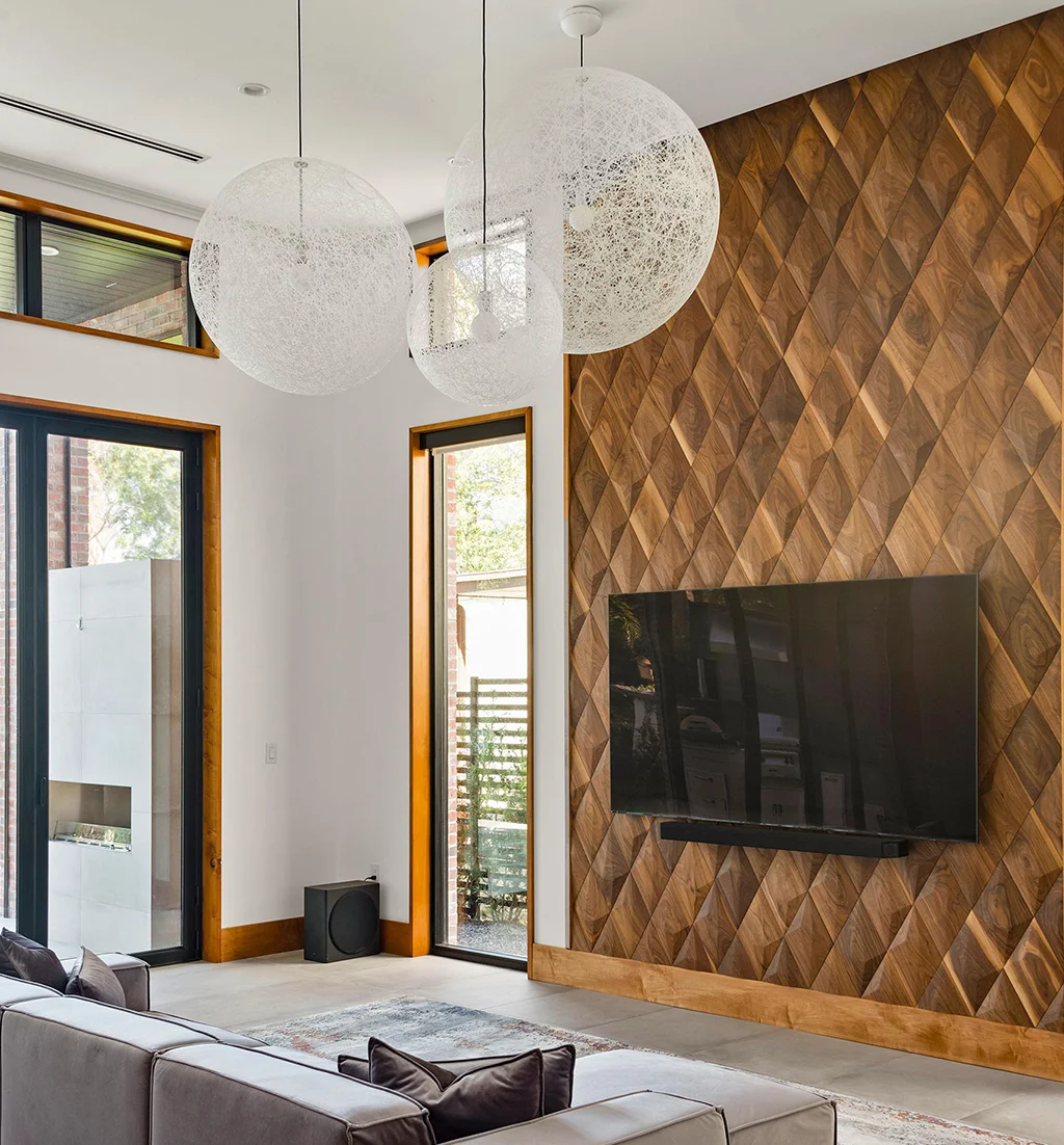 Modern living room fireplace wall decorated with geometric wooden panels.