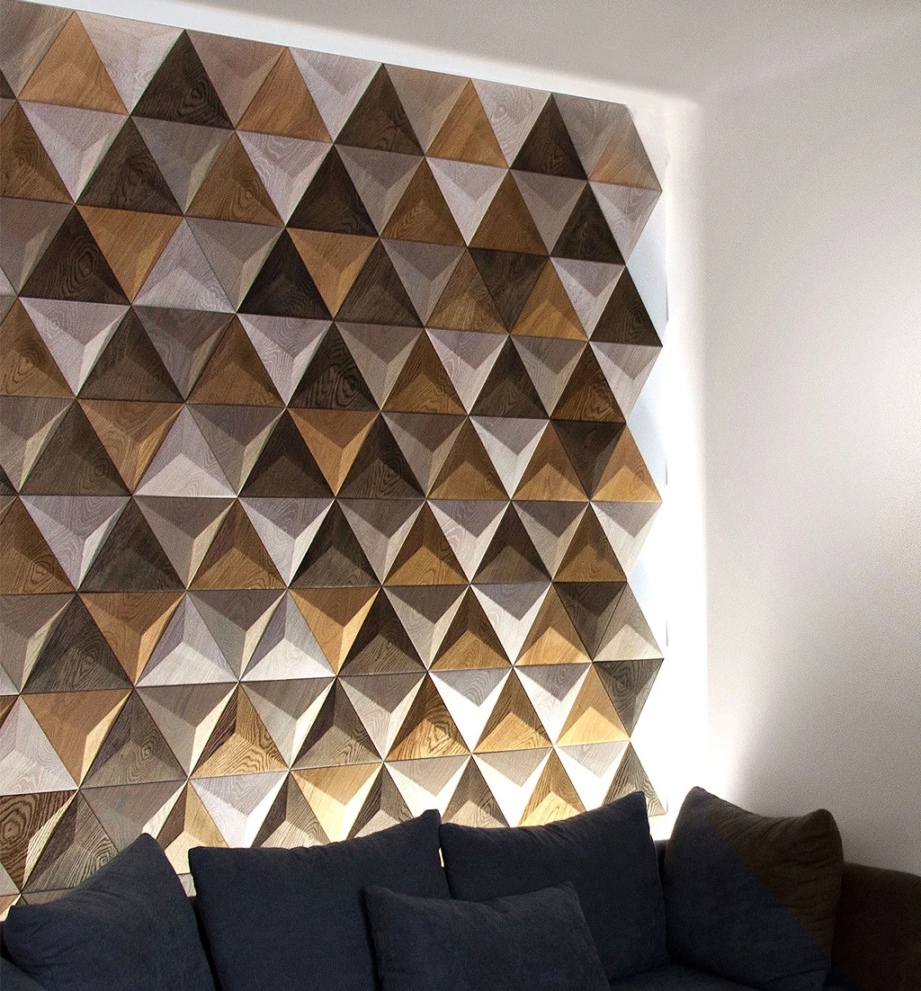 Decorative 3D oak triangle wood panel wall featuring side LED lighting and a dark blue sofa with cushions.